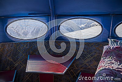 Hotel in the shape of an alien flying saucer standing high in the mountains among the snow capped mountain peaks. Dombay Editorial Stock Photo