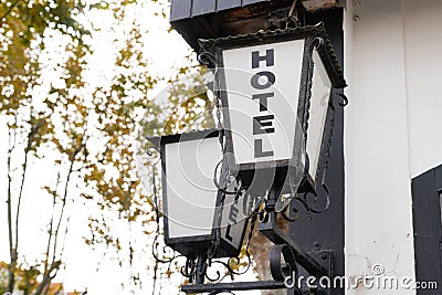Hotel sign text write on old lamp vintage retro front of building in tourist city Stock Photo