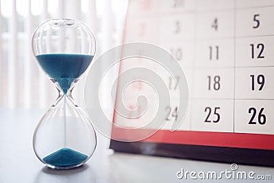 Hour glass and calendar important appointment date, schedule and deadline Stock Photo