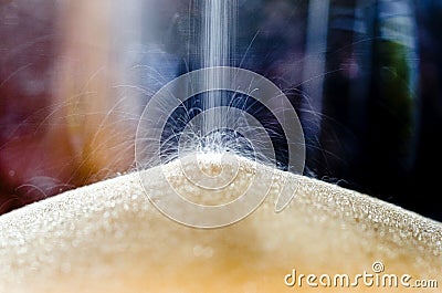 Close-up of sand falling in an hour glass Stock Photo