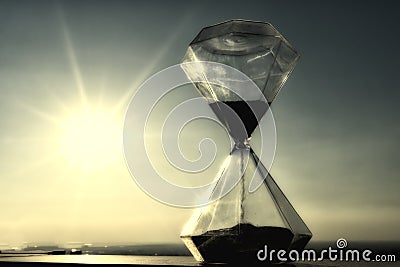 Hourglass on a background sunset Stock Photo