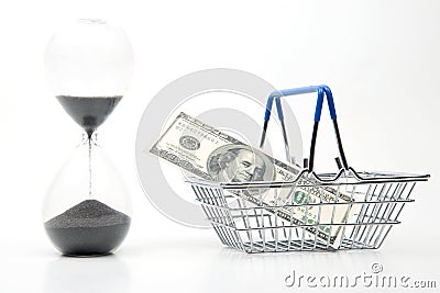 Hourglass, dollars and shopping cart for market groceries on white background Stock Photo