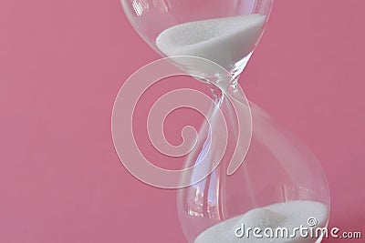 Hourglass on pink background - Concept of health, fertility and biological clock in women Stock Photo