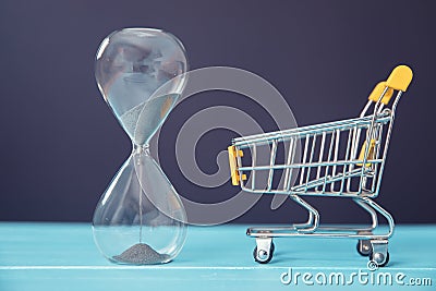 Hourglass and shopping cart Stock Photo