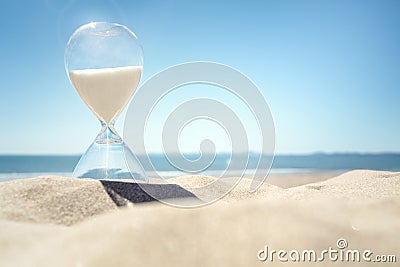 Hourglass time on a beach in the sand Stock Photo