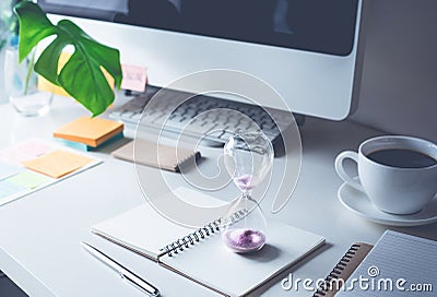 hourglass with worktable office.Time,motivation concept Stock Photo