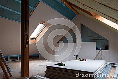 House attic insulation and renovation. Drywall construction Stock Photo