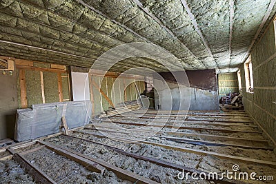 House attic under construction. Mansard walls and ceiling insulation with rock wool. Fiberglass insulation material in wooden fram Stock Photo