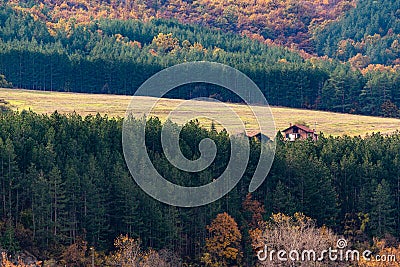 House with big farmland on a forest hill in autumn with vivid colors and sharp detail in Bulgaria, Eastern Europe Stock Photo