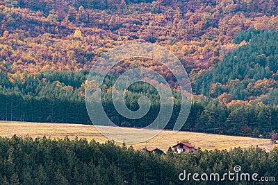 House with big farmland on a forest hill in autumn with vivid colors and sharp detail in Bulgaria, Eastern Europe Stock Photo