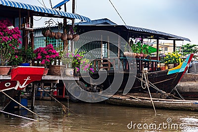 House boats with paper flowers, orchids and yellow flowers for Tet New Year Celebration, Mekong Delta, Vietnam Editorial Stock Photo