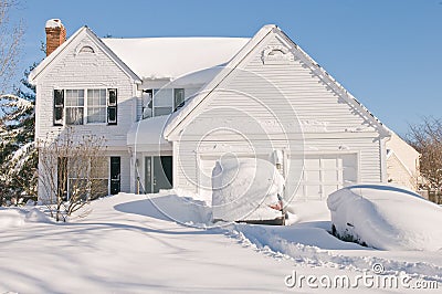 House and cars after snowstorm Stock Photo