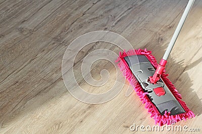 Washing Dust on Wooden Floor with Mop Stock Photo