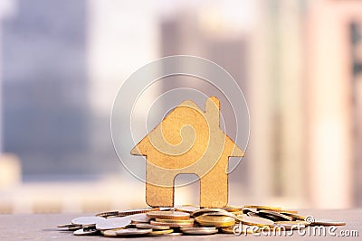 House and coins stack for saving to buy a house. Property investment and house mortgage financial concept. Stock Photo