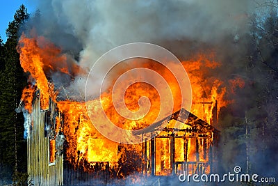 House completely engulfed in flames Stock Photo