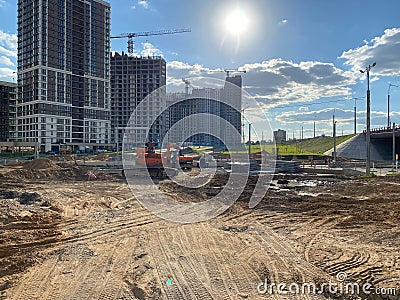 House construction with construction cranes on a background of blue sky. Construction and repair. Industry. Building sector. Stock Photo