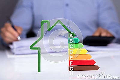 House With Energy Efficiency Rate On Desk Stock Photo