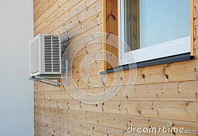 House exterior knotty pine, ceder wood wall siding and panel with air conditioner outdoor unit and window Stock Photo