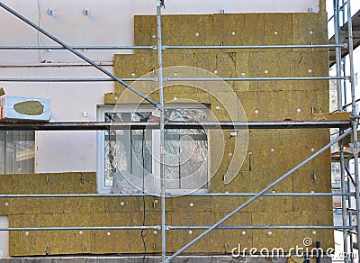 House External Wall Insulation with Fiberglass. Energy Saving Concept. Stock Photo