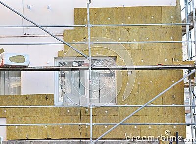 House External Wall Insulation with Fiberglass. Energy Saving Concept. Stock Photo