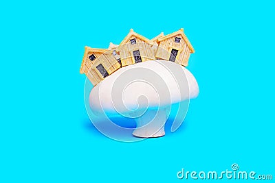 House figurines on a large white mushroom on blue Stock Photo