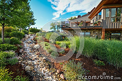 House and garden with creek Stock Photo