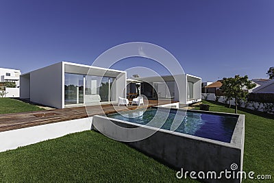 House with garden swimming pool and wooden deck Stock Photo