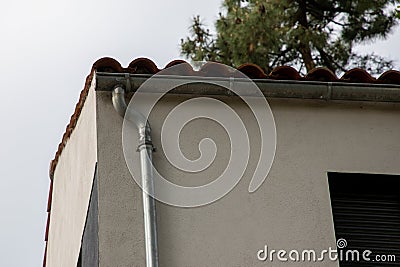 House gutters round rain grey modern aluminum gutter silver waterproofing home corner roof facade Stock Photo