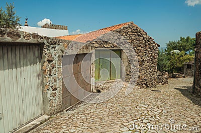 House with iron garage gate on cobblestone alley Stock Photo