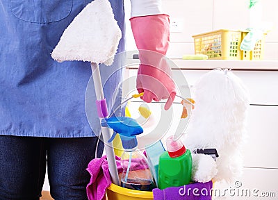 House keeper with cleaning equipment in bucket Stock Photo