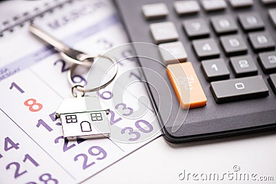 A house key on a calendar background Stock Photo