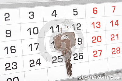 A house key on a calendar background Stock Photo