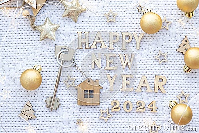 House key with keychain cottage on festive knitted background with stars, lights of garlands. Happy New Year 2024-wooden letters, Stock Photo