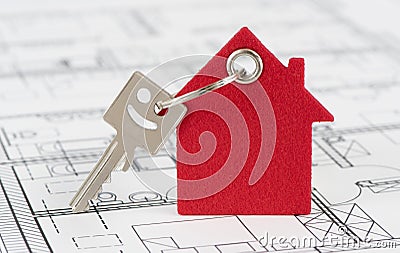 House key on keyring over construction plan Stock Photo