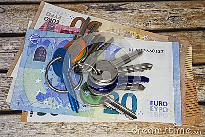 House keys over euros banknotes. Rental prices concept. Stock Photo