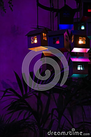 Houses with lights within on a purple background Stock Photo