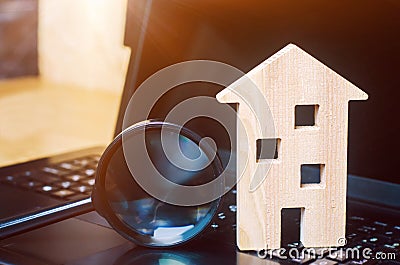 House and magnifying glass on the keyboard. The concept of housing search in the the Internet. Buy an apartment for sale online. Stock Photo
