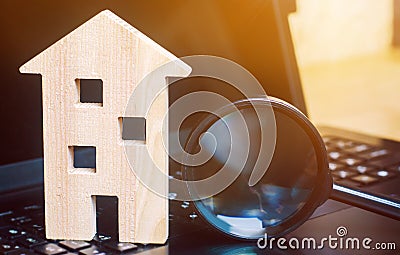 House and magnifying glass on the keyboard. The concept of housing search in the the Internet. Buy an apartment for sale online. Stock Photo