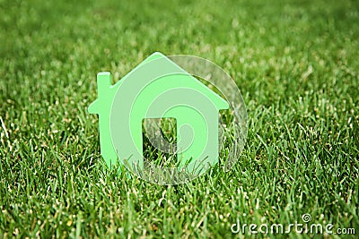 House model on green lawn. Real estate agent Stock Photo