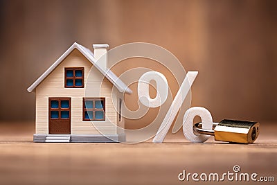 House Model Near Percentage Sign With Keypad Lock Stock Photo