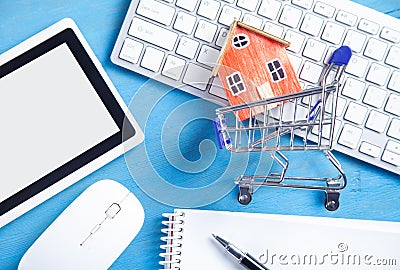 House model, shopping cart and business objects. Buying house Stock Photo