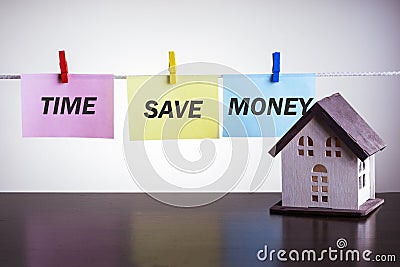 House model and text TIME SAVE MONEY Stock Photo