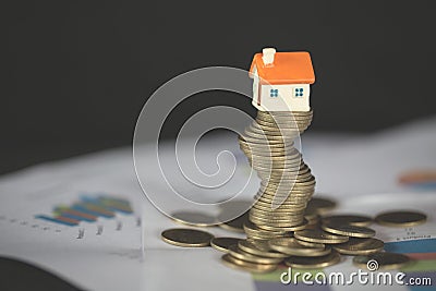 House model on top of stack of money as growth of mortgage credit, Concept of property management. Invesment and Risk Management Stock Photo