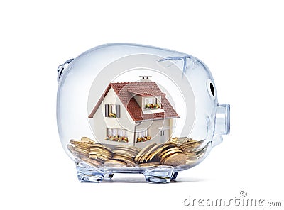 House on money inside transparent piggy bank Stock Photo