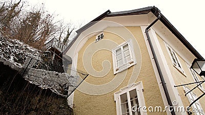 House near a rock face in Salzburg, winter time Stock Photo