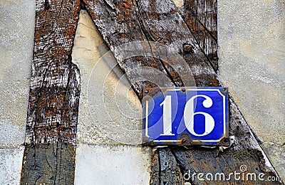 House number 16 on antique rustic wall, old, rusty enamel sign Stock Photo