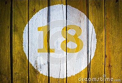 House number or calendar date in white circle on yellow toned Stock Photo