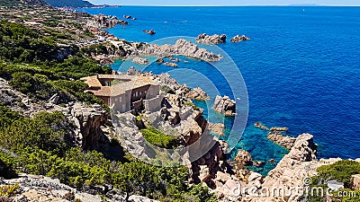 House overhang rocks and sea Stock Photo