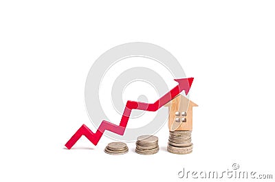 House on penny and arrow up. The concept of a rise in price of property. Increasing the cost of buying a property, rent. Investing Stock Photo