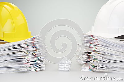 House between pile overload document have engineer hat on top Stock Photo